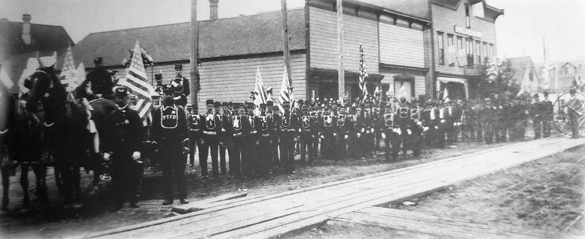 historical image of Port Townsend fire department standing alongside a street